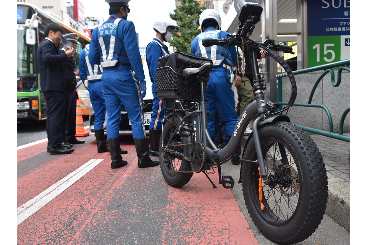 ペダル付き電動バイク「モペット」の取り締まりをする警察官／画像は2024年新宿で実施された際のもの［Photo：時事通信フォト］